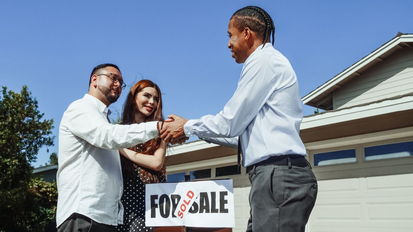 First home buyers celebrating their sold property